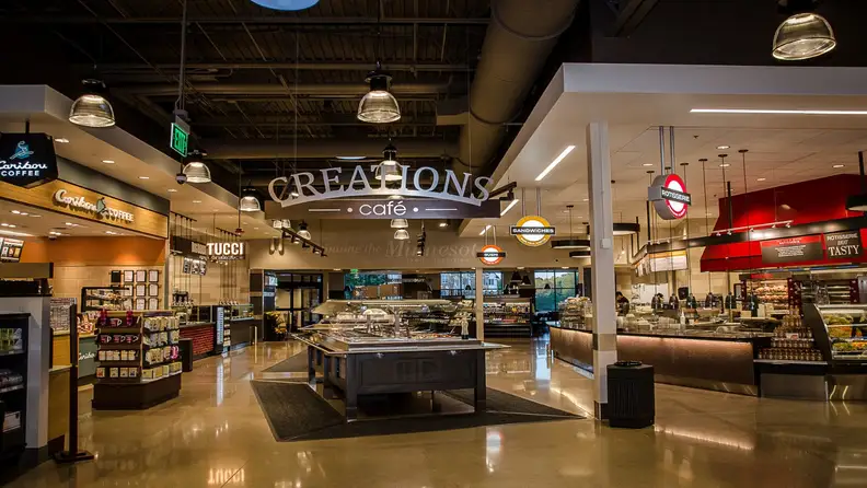 Creations Café counter with rotisserie, sushi, and sandwich stations