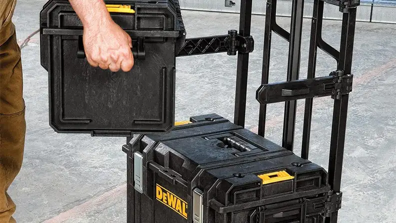 A person carries a tool kit.