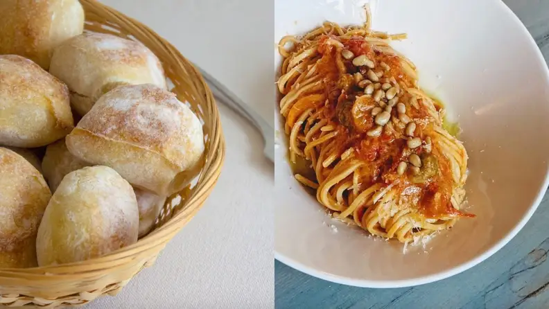 On left, basket of sourdough rolls. On right, plate of linguine with sauce.