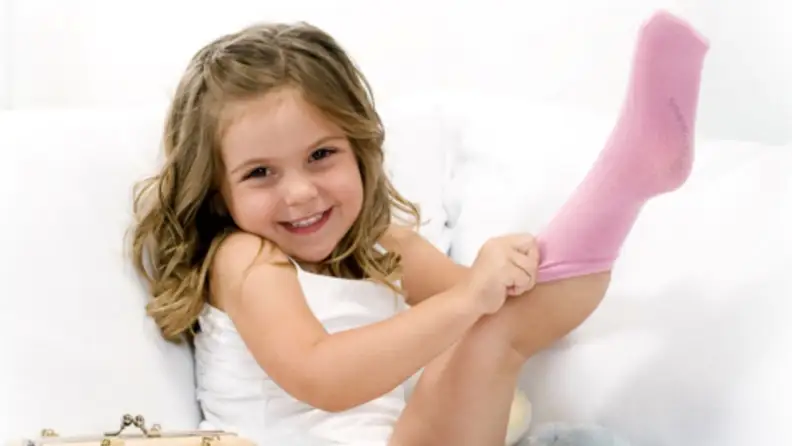Girl pulling on seam-free socks