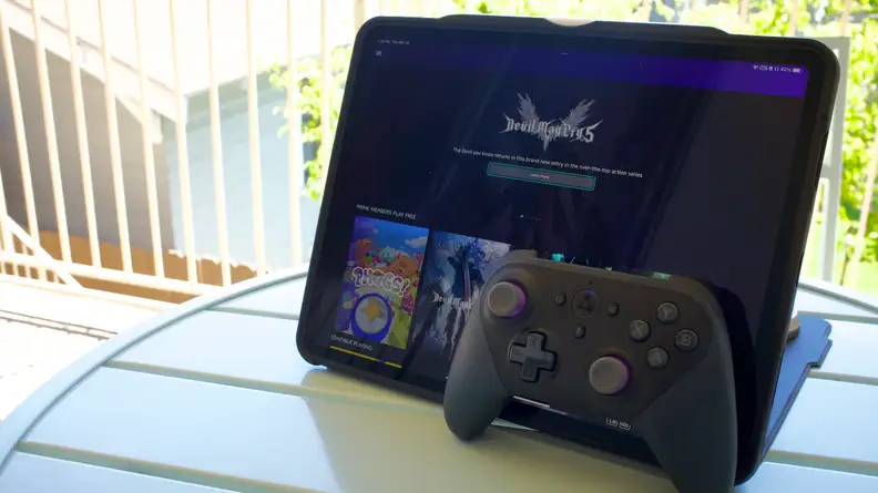 An iPad Pro showing Amazon Luna's home page, with an Amazon Luna controller in front of it, both propped on a table.