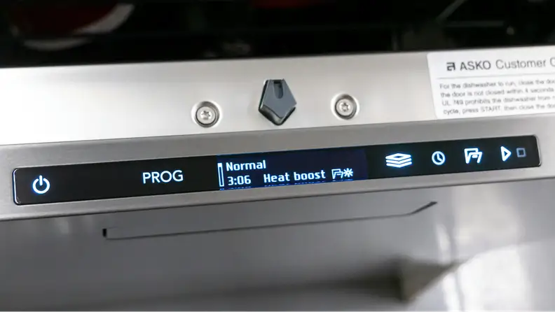 The Asko dishwasher’s interface is shown on the top of its door, with the Heat Boost cycle selected.