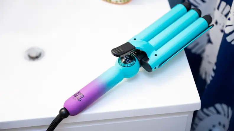 One of the best hair wavers sitting on a white sink basin.