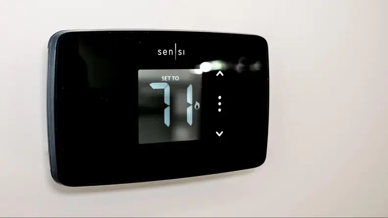 The Sensi Lite thermostat appears on a gray wall.