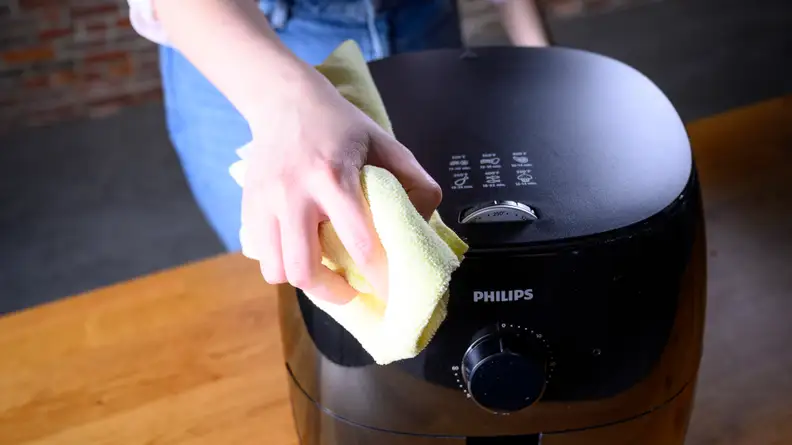 Wiping down an air fryer