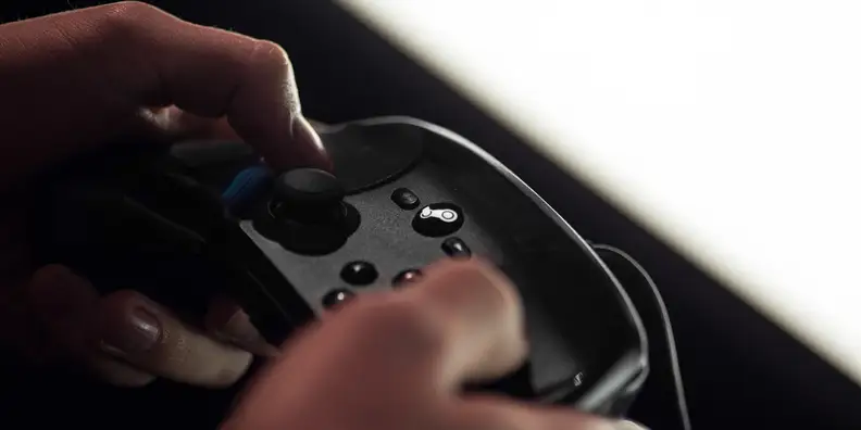 A close-up photo of the Valve Steam Controller in use.