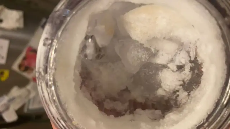 Partially shaven ice inside of cup.