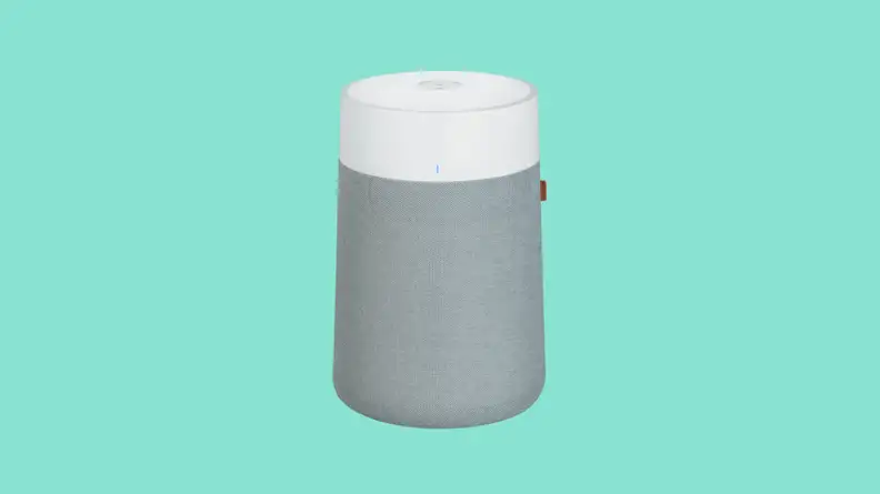 The rounded gray and white Blueair sits on a teal background.