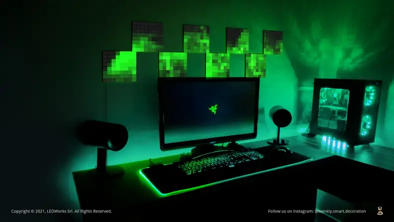 A picture of a gaming setup with several light panels on the wall, displaying low-res, glitchy-looking art.