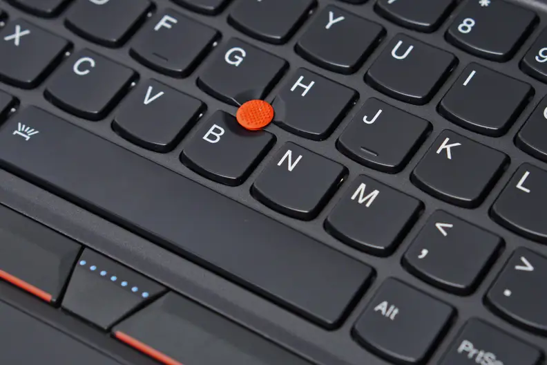 In the center of the keyboard is a red button that can be used to control the mouse.