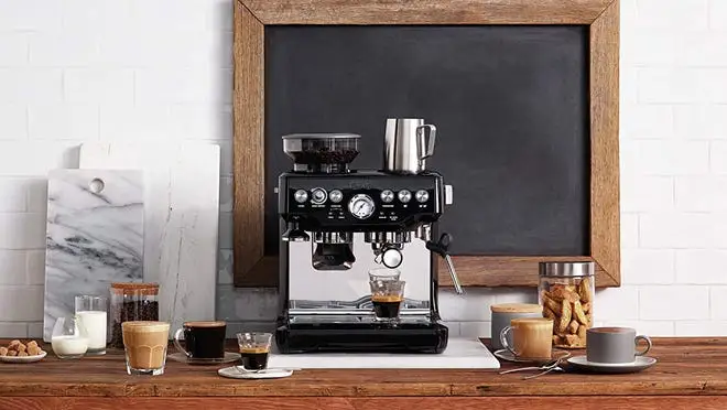 A Barville Barista Express sitting in front of a coffee shop like spread.