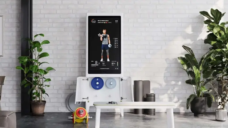 The Tempo Studio display with a Tempo bench and dumbbells.