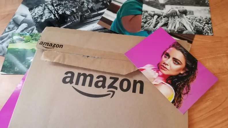 Amazon logo on a brown envelope with a photo of a woman on top.