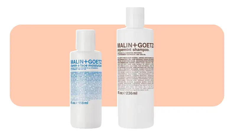 Two white bottles of skincare stand next to each other.