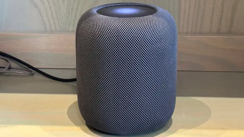 A second-gen Apple HomePod sits on a desk
