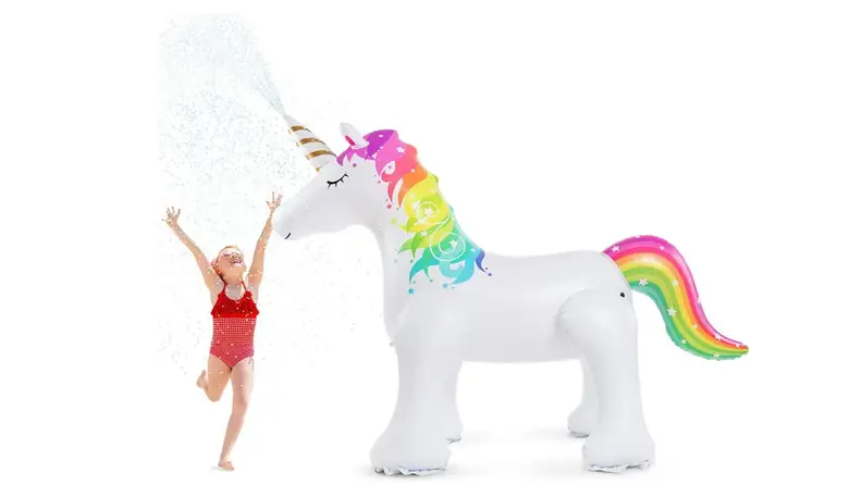 A little girl runs through water sprayed by a unicorn sprinkler