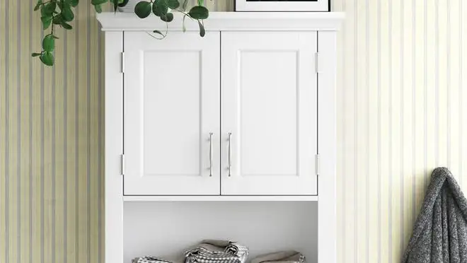 White over-the-toilet shelf in pale yellow bathroom.