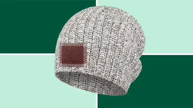 A grey Love Your Melon Beanie on a dark and light green background.