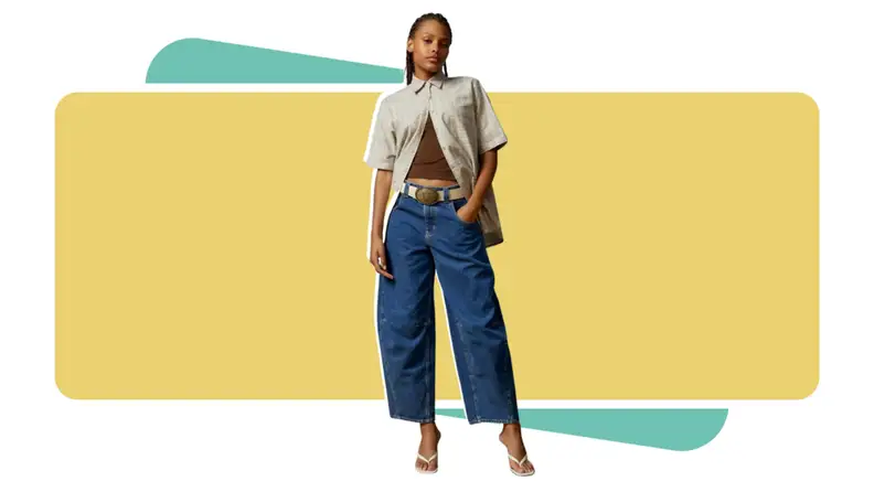 A model wearing dark blue jeans with a plaid shirt.