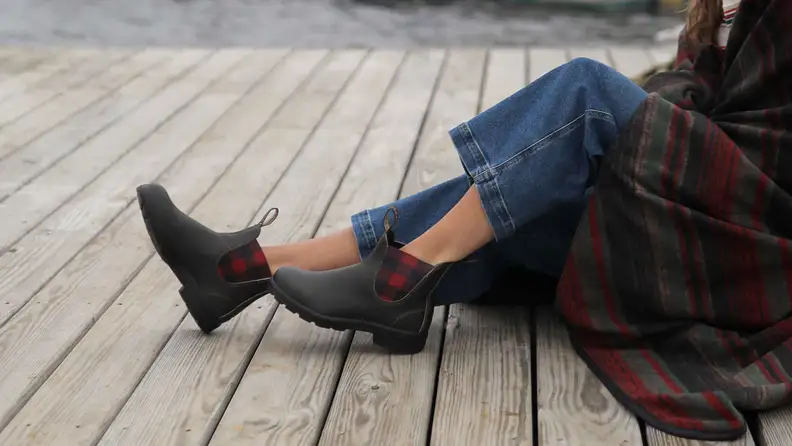 Photo of a model's legs. She wears blue jeans and Blundstone x L.L.Bean Chelsea boots.