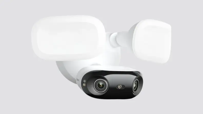 A security camera placed on a gray background