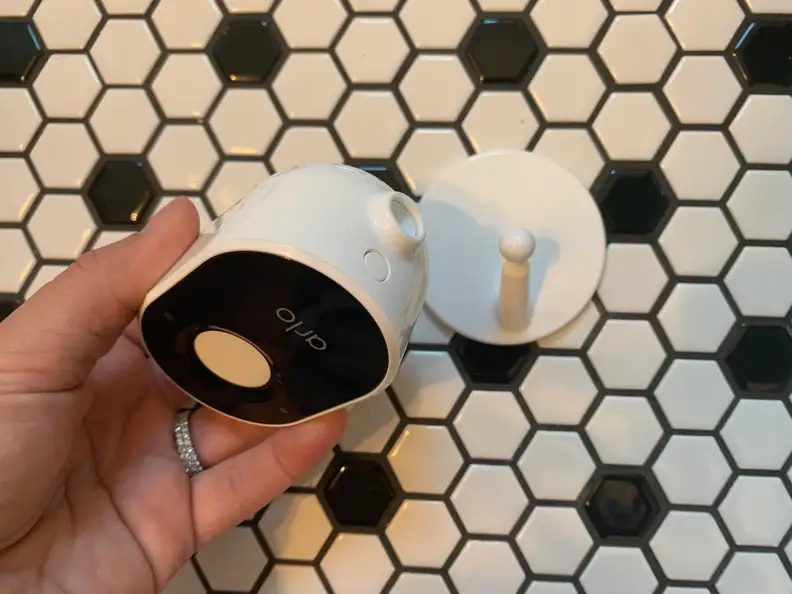 The Arlo Essential Indoor Security Camera separated from the base/mounting plate.