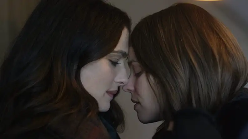 A still from _Disobedience_ featuring Weisz and McAdams nearly kissing.