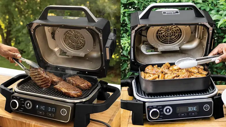 Steak and chicken breasts being cooked inside of the Ninja Woodfire ProConnect XL Outdoor Grill & Smoker while being flipped with cooking tongs outdoors.