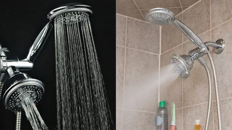 Two shower heads dispersing water in shower.