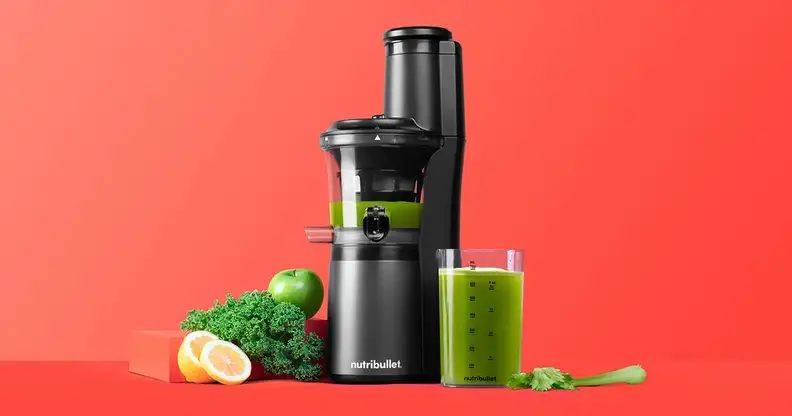 A NutriBullet Slow Juicer is in the center, grinding green juice with green vegetables surrounding it.