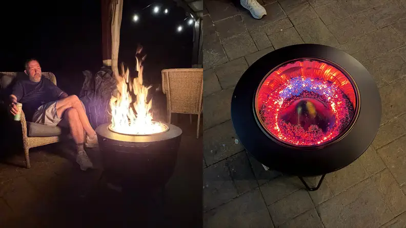 A man sits by a fire; looking down into a firepit