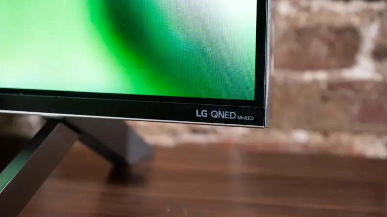 A close-up of the LG logo on the front of the LG QNED99 8K TV