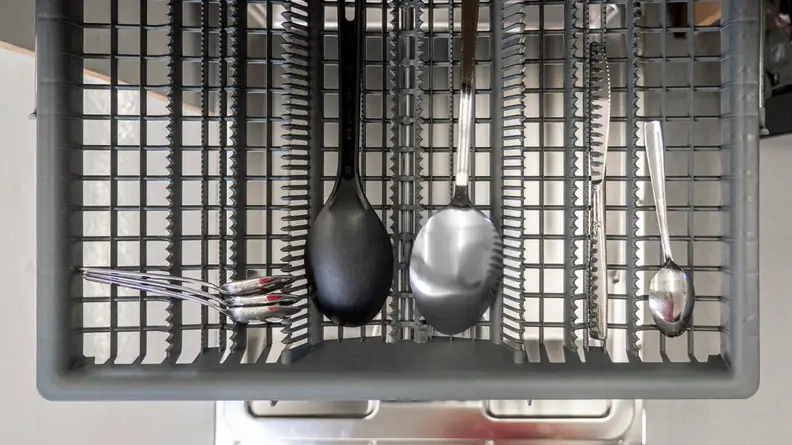 A top-down shot of the third rack, which is loaded with a few ladles and pieces of silverware.