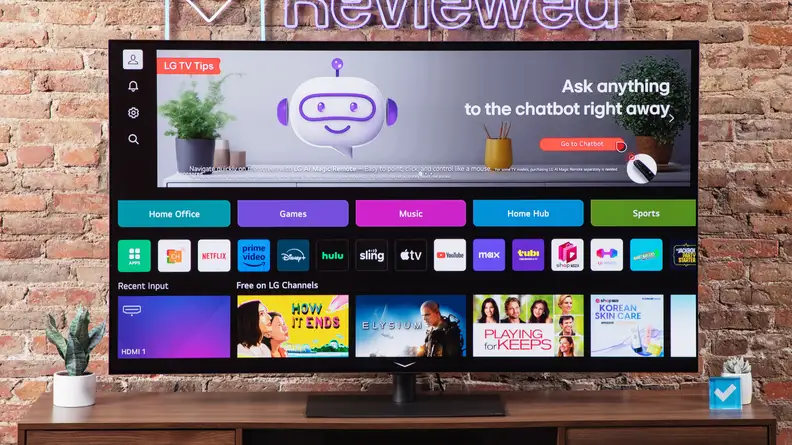 An LG G4 OLED TV on a wood entertainment center with a Reviewed sign above the TV.