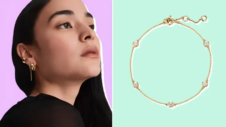 A woman wearing gold hoop earrings next to a delicate gold chain bracelet with bezel-set stones.