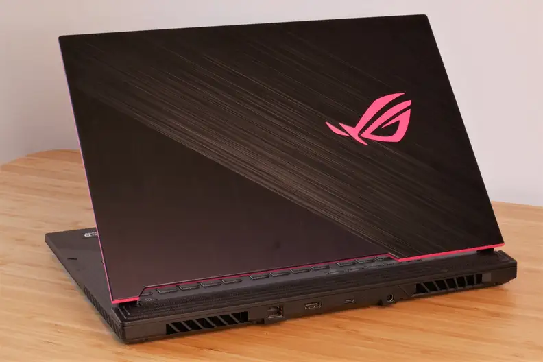 A photo of the Asus ROG Strix G512LI gaming laptop on a desk with rear ports visible