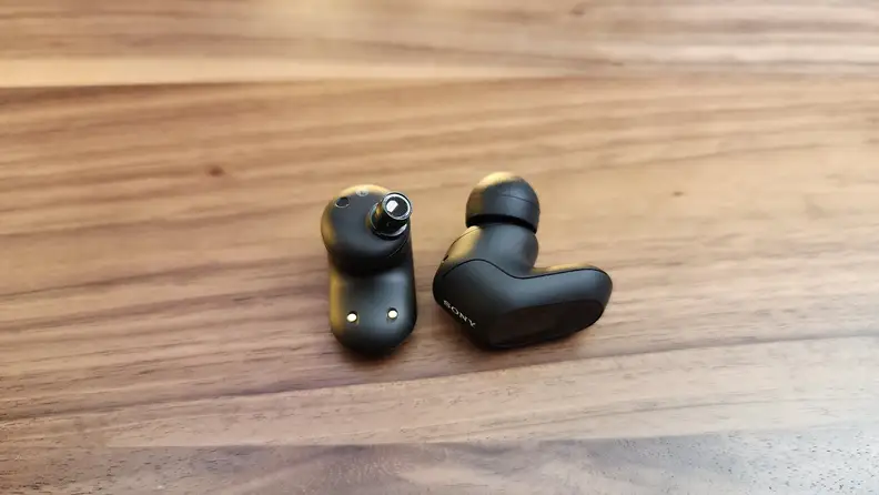 The Sony Inzone Buds on a wood table.