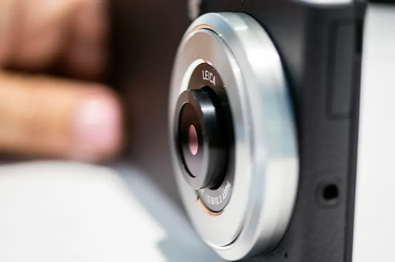 The lens pops out slightly while in camera mode and retracts while not.