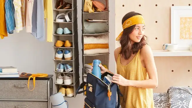 A person takes a garment out of their closet.