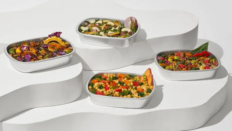 All four Daily Harvest Harvest Bakes spread on minimalist white steps