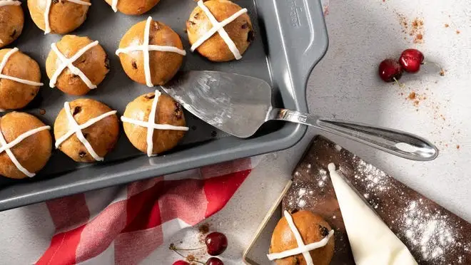 Baked goods in pan next to spatula.