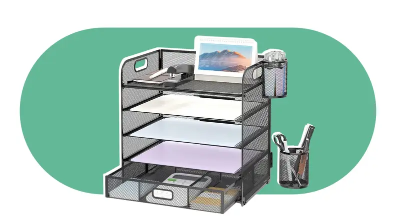 Multi-level desk organizer with paper inside and pens on top.