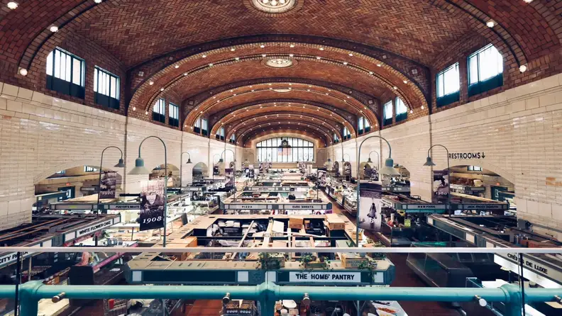 Interior of West Side Market's vaulted, tiled hall lined with vendor stalls