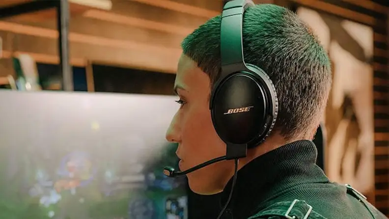 Image of person sitting at desk with headphones on