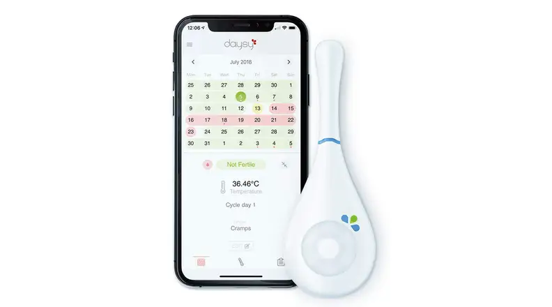 Daysy thermometer next to phone with DaysyView app on screen