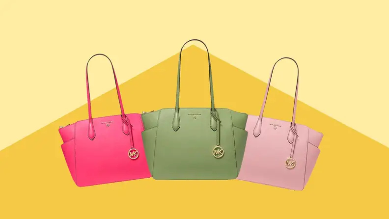 Three Michael Kors purses - hot pink, mint green, and rose pink - in front of a yellow-gold background.