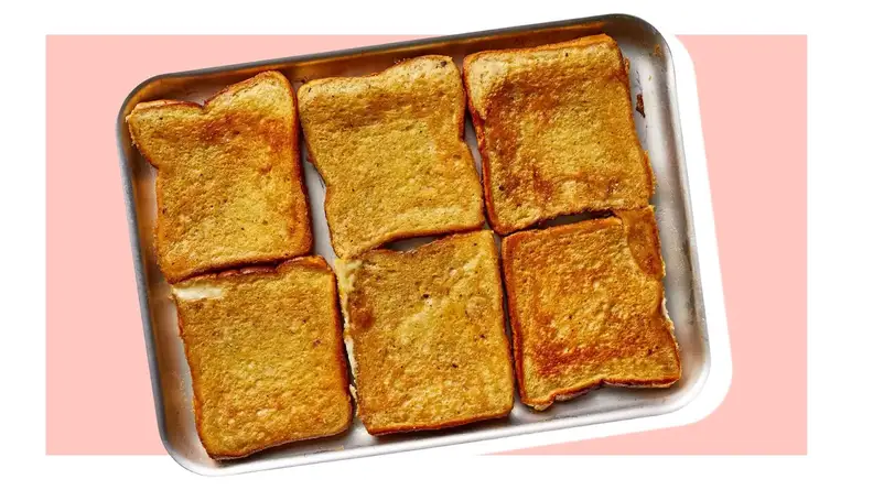 Cooked french toast on cooking tray.