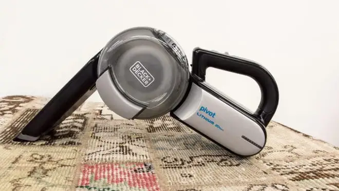 handheld vacuum vacuuming carpet