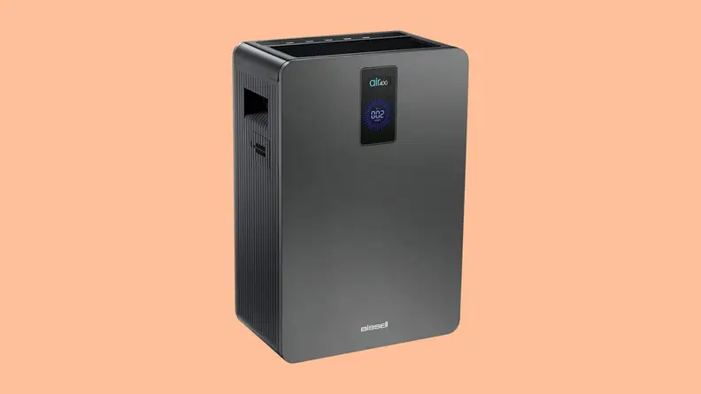 A Bissell air400 purifier against a peach color background.