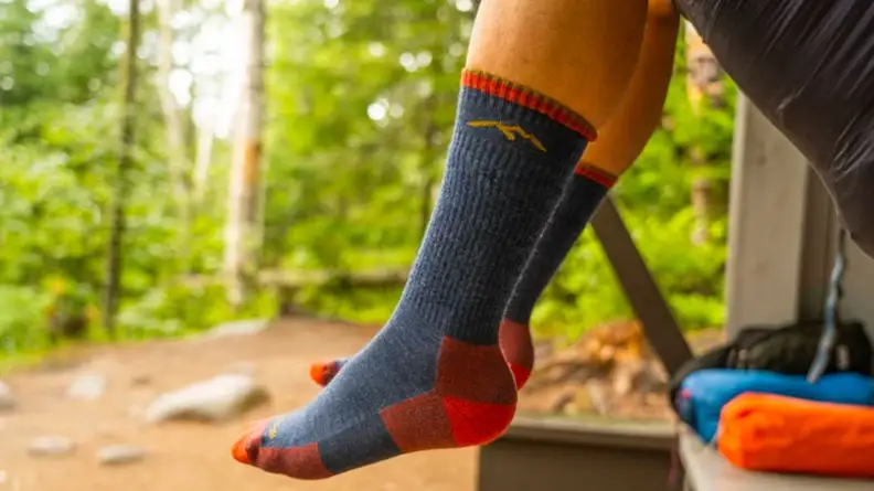 A pair of Darn Tough Vermont socks on a hiker's legs.